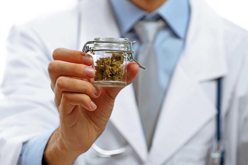 Doctor Holding Jar Of medical Marijuana