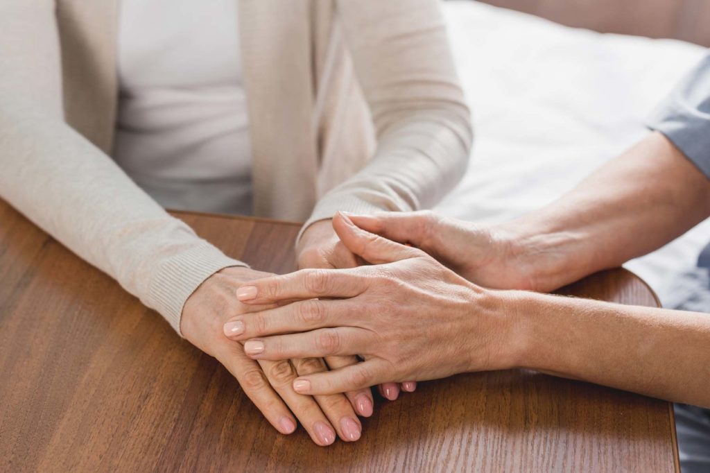 Woman Holding Hand Of A Caregiver