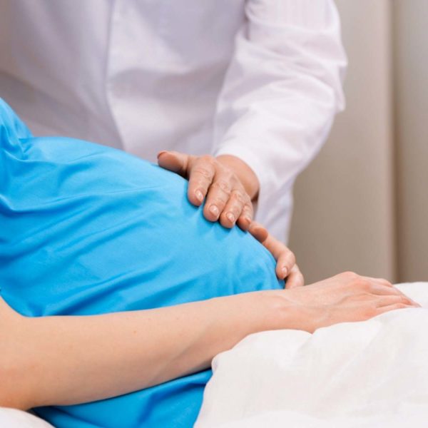 Doctor Touching Pregnant Woman's Belly