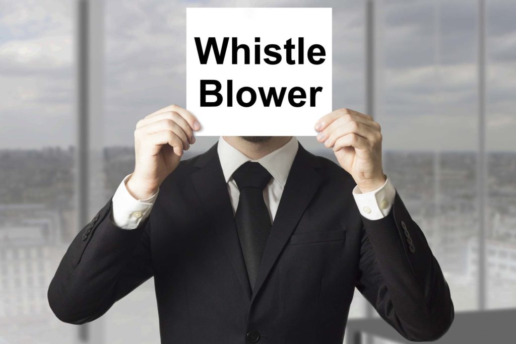 Man Holding Sign That Says Whistle Blower