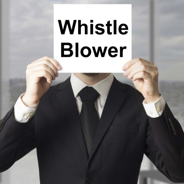 Man Holding Sign That Says Whistle Blower