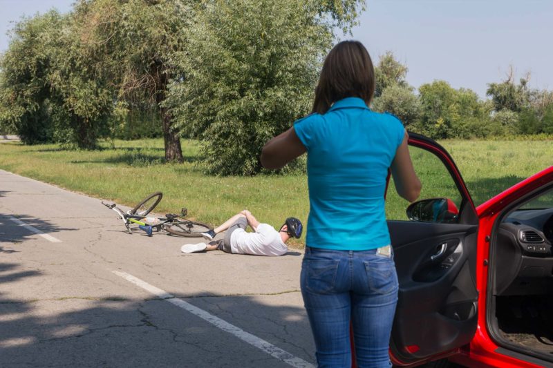 Woman Observing Injured Cyclist