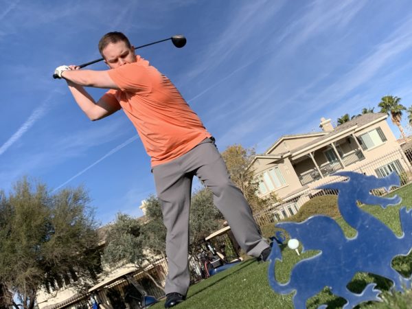 Golfer Swinging At ball