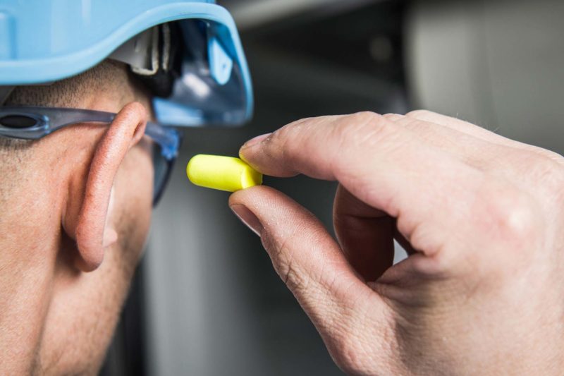Man Inserting Ear Plug Silencer